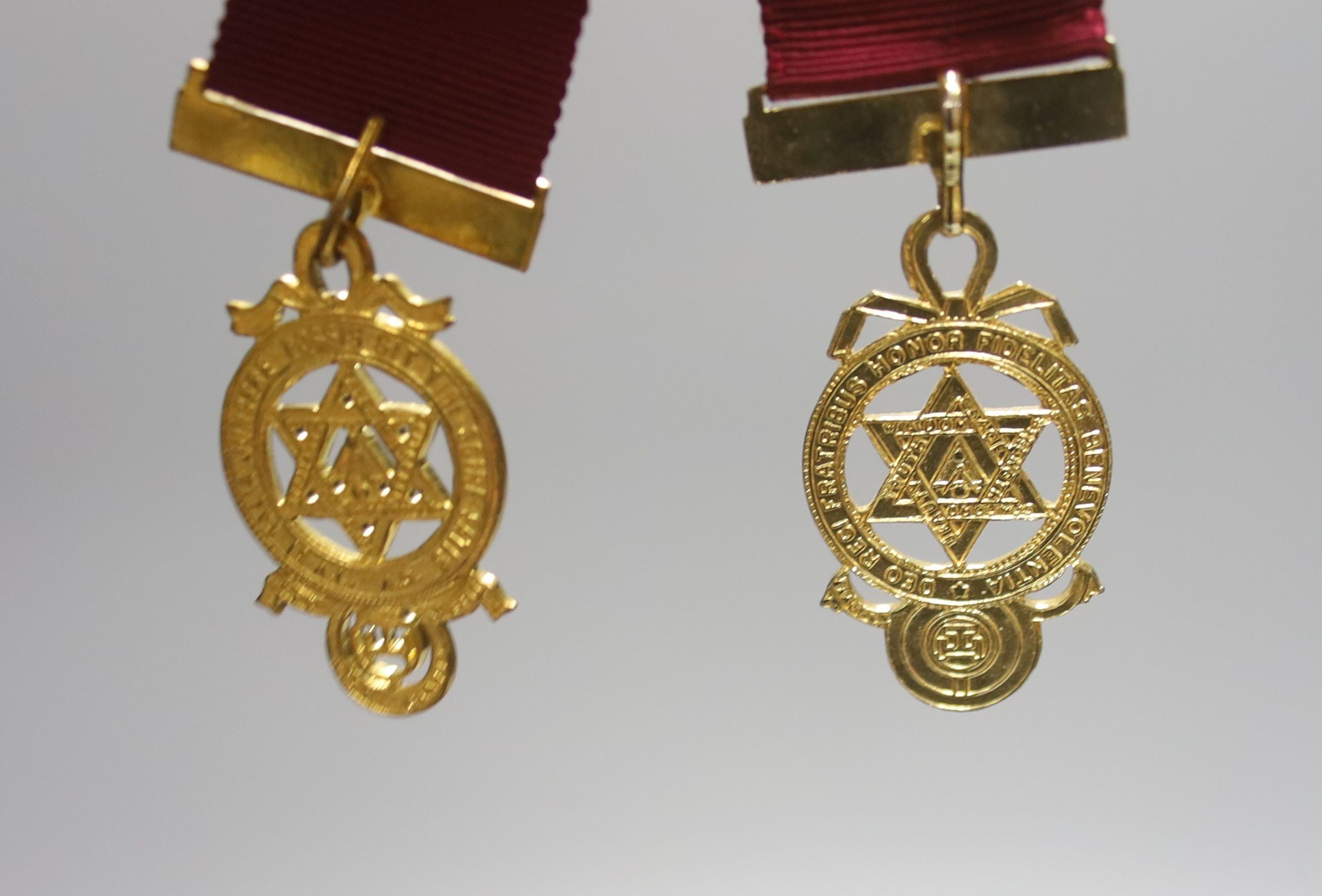 A group of Masonic sashes with metal medals and a collection of gilt metal cased medals
